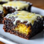 Close-up of a fudgy lemon brownies square showing a rich chocolate exterior and a bright yellow lemon swirl center.