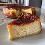 A close-up slice of creme brulee cheesecake showing the creamy filling and caramelized sugar topping.