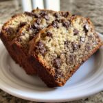 Three moist slices of homemade chocolate chip banana bread recipe served on a white plate.