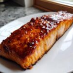 A perfectly cooked fillet of salmon covered in a thick, glossy maple bourbon glazed salmon topping.