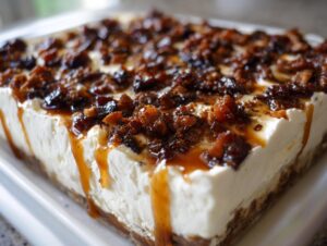 Close-up of creamy whipped feta dip topped with crumbled bacon, dates, and a caramel drizzle.