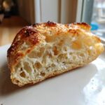 Close-up showing the airy, open crumb structure of a Sourdough Discard Pizza Crust.